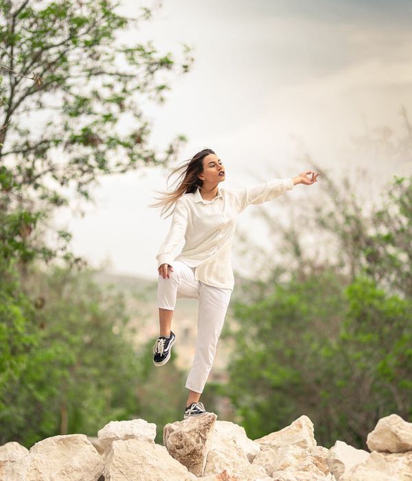Woman in a graceful yoga pose finding balance in a calm environment.